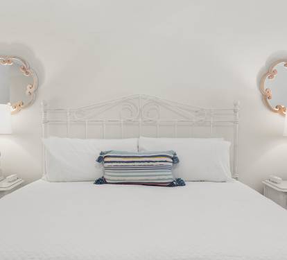 Drift off peacefully in your serene bedroom, with crisp white linens and charming nautical accents creating the perfect coastal retreat.