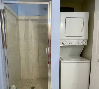Guest bathroom with a washer and dryer.