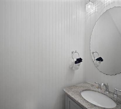 Chic half bathroom with white beadboard walls and a granite countertop. Features sleek chrome fixtures and a modern light fixture for a clean, coastal look.