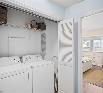 Convenient laundry closet with a full-size washer and dryer.