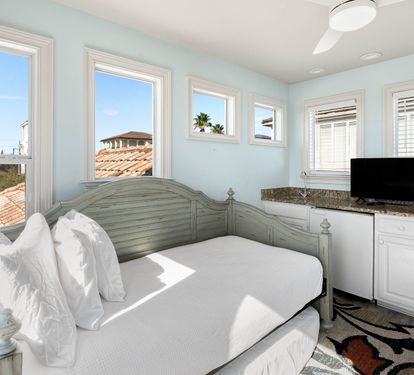 Drift off in your serene bedroom, where soft light pours through windows and coastal breezes refresh your dreams.