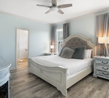 Step into your serene bedroom sanctuary with elegant furnishings, plush bedding, and soft blue walls creating the perfect retreat for restful nights.