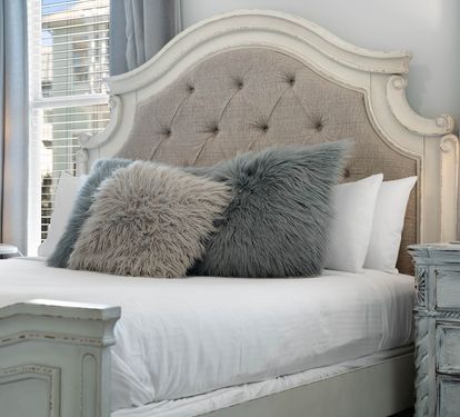 Sink into the plush linens and fluffy pillows of your elegantly appointed bedroom, where soft lighting creates the perfect ambiance for rest.