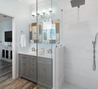 Your private bathroom features a spacious glass shower, double vanity with rustic mirrors, and modern fixtures for a refreshing start to your day.