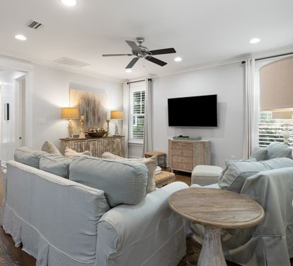 Relax in your elegant living space with plush seating, warm lighting, and coastal-inspired décor creating the perfect atmosphere for unwinding.