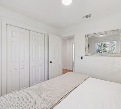 King Guest Suite - Offering Ample Storage + Flat-Screen TV
