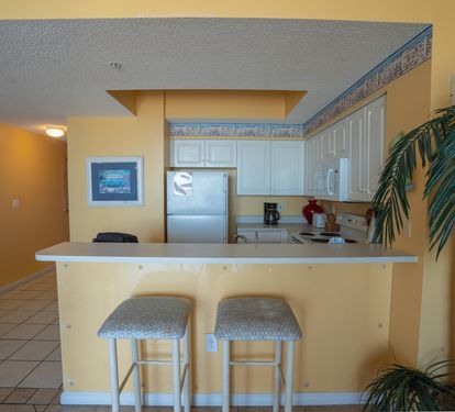 Kitchen with two stools at the breakfast bar.