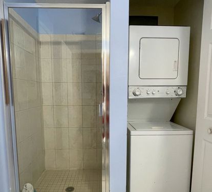 Guest bathroom with a washer and dryer.