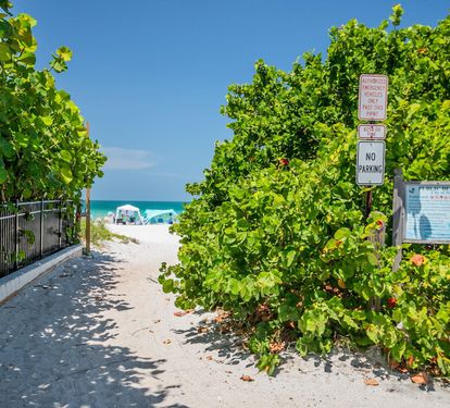 A quick, shaded walk through native sea grape leads straight to the sand — Coastal Cottage is just two blocks from this beach access.