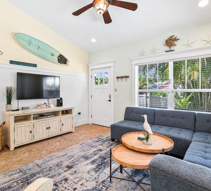 Relax in front of the flat-screen TV in a light-filled living space finished with playful beach touches and cozy seating.