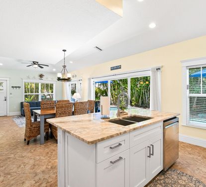 A spacious island with bar seating anchors the fully updated kitchen, open to the dining and living areas.