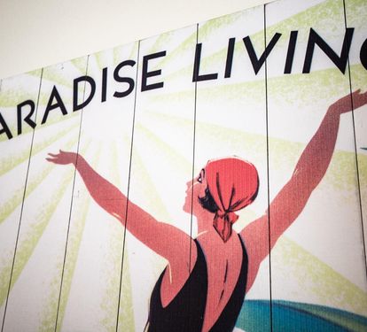 Bright, playful wall art adds to the fun, island-getaway atmosphere at Coastal Cottage.