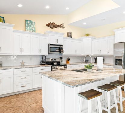 Bar seating at the island makes for easy breakfasts or casual meals in the open, light-filled kitchen.