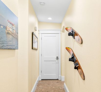A bright hallway leads to the bedrooms, finished with playful coastal touches along the way.