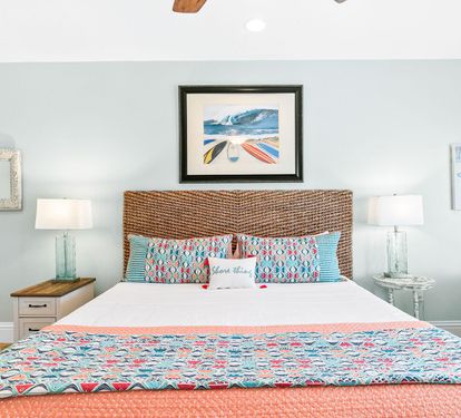 A closer look at the coral and turquoise bedding that brings this bedroom's beach palette together.