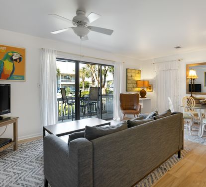 Relax in your bright, open living space with a cozy sofa facing the TV, while the dining area and balcony beckon for memorable moments together.