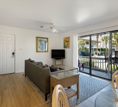 Relax in your bright, airy living space with comfortable seating and direct balcony access to tropical views.