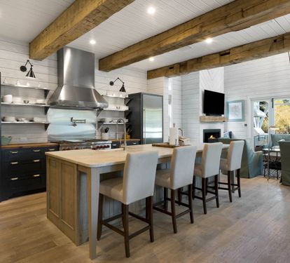 You'll love cooking in this stunning gourmet kitchen featuring exposed beams, premium appliances, and island seating for memorable meals together.