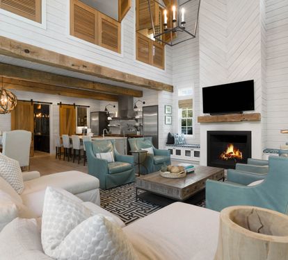 Relax in your spacious living room with soaring ceilings, exposed beams, and a crackling fireplace creating the perfect atmosphere for memorable evenings together.