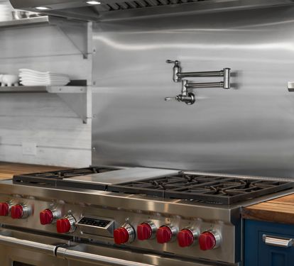 Create culinary masterpieces on your professional-grade gas range with pot filler convenience and abundant storage for all your cooking needs.