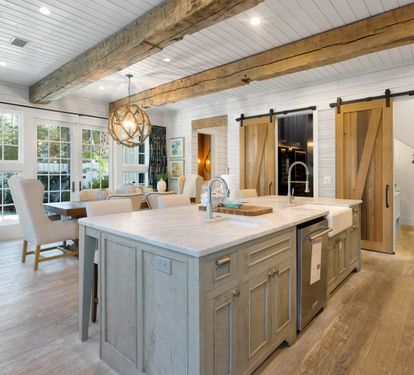 Cook and gather in your rustic-chic kitchen where exposed beams meet modern appliances, perfect for creating memorable meals together.