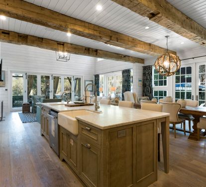Your dream kitchen awaits with rustic wood beams, gleaming countertops, and a cozy dining nook bathed in natural light.