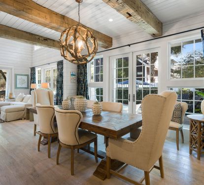 Gather around your stunning farmhouse dining table, where rustic beams meet coastal elegance for memorable meals together.