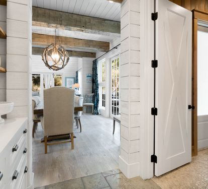 Step into your charming farmhouse kitchen where rustic wood beams and bright white cabinetry create the perfect blend of comfort and style.