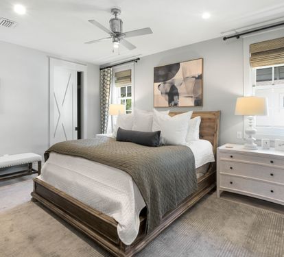 Sink into crisp white linens and cozy textures in your serene bedroom retreat, where warm lighting and thoughtful decor create the perfect haven.