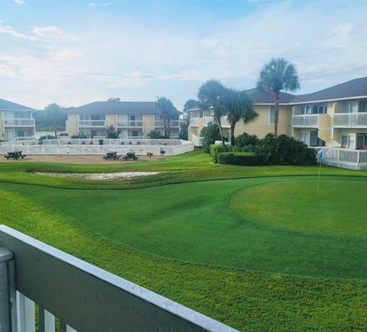 Wake up to stunning golf course views from your private balcony, with perfectly manicured greens stretching toward palm-lined grounds.