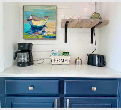 Your coastal-themed kitchenette features everything needed for morning coffee and light meals, with charming nautical touches throughout.