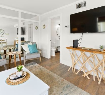 Unwind in your stylish living space with coastal-inspired touches, where cozy seating and modern amenities create the perfect home away from home.