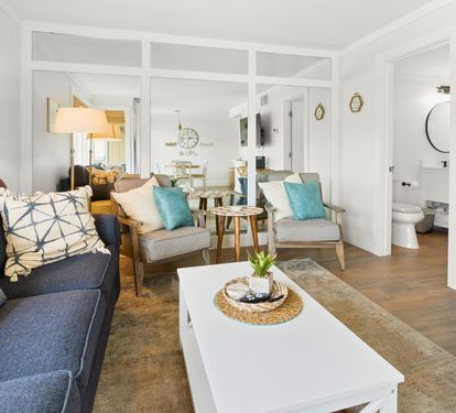 Relax in your bright, coastal-inspired living space with comfy seating, nautical touches, and an open layout perfect for unwinding.