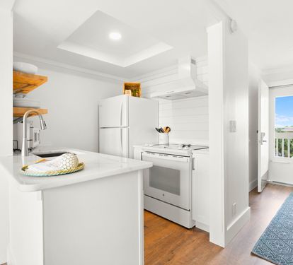 Your bright kitchen awaits with modern appliances and sleek countertops, perfect for preparing meals while enjoying the open-concept flow.