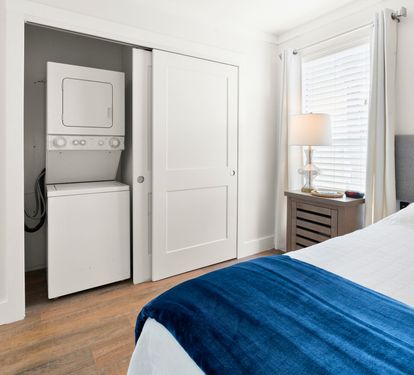 Your bright bedroom features convenient in-room laundry facilities, making longer stays effortless and comfortable.