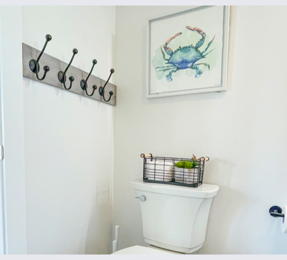 Your private bathroom features thoughtful coastal touches and convenient hooks for your towels and belongings.