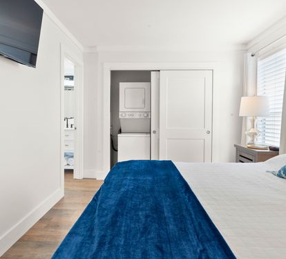 Unwind in your serene bedroom with crisp linens, modern conveniences, and a peaceful blue accent that invites restful nights.