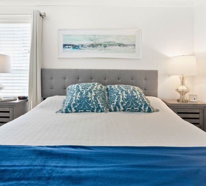 Sink into coastal comfort in your serene bedroom, where ocean-inspired blues and soft lighting create the perfect retreat for restful nights.