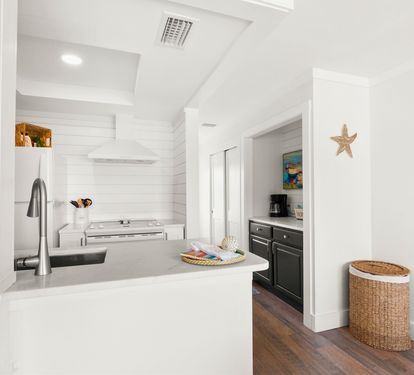 Your coastal-inspired kitchen features sleek countertops and modern appliances, perfect for preparing memorable meals during your stay.