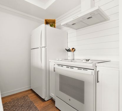 Your bright, well-equipped kitchen features modern appliances and crisp white finishes, perfect for preparing meals during your stay.