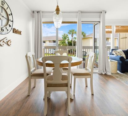 Gather around your bright dining table where morning coffee meets ocean breezes through sliding doors to your private balcony.