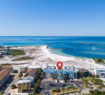 Aerial view showcasing the property's prime beachfront location on Florida's stunning emerald coast, with pristine white sand beaches and turquoise Gulf waters just steps away.