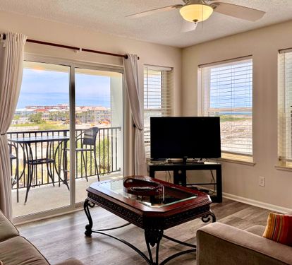 Relax in your bright living space where water views frame every moment. Unwind on plush seating, enjoy entertainment on the flat-screen TV, and step onto your private balcony to soak in the coastal scenery.