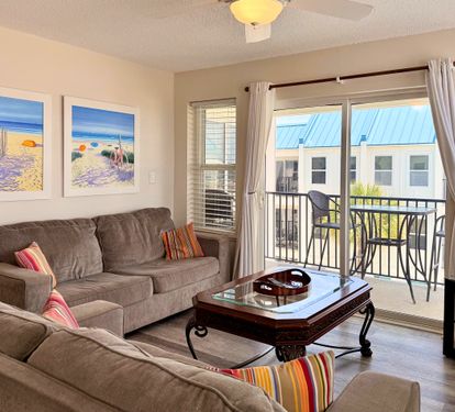 Picture yourself unwinding in this bright, comfortable living space with soft seating and coastal artwork setting a relaxed beach vibe. Your private balcony awaits for morning coffee or sunset views.