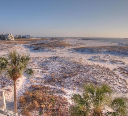 Peaceful East Pass views with sugar-white dunes and coastal grasses—watch boats glide by and enjoy stunning sunsets just moments away.