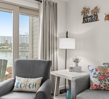 Settle into your waterfront paradise with coastal charm and stunning lake views from your cozy seating area.
