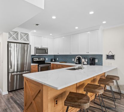 Your fully equipped kitchen features modern appliances, stylish island seating, and everything needed for memorable meals together.
