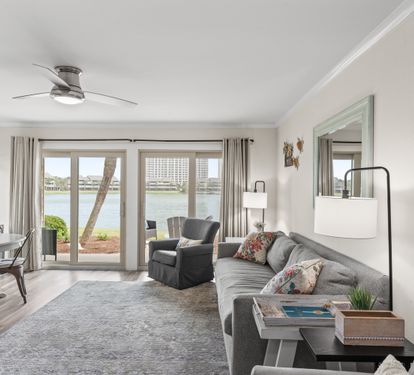 Unwind in your spacious waterfront living room with stunning lake views through floor-to-ceiling windows.