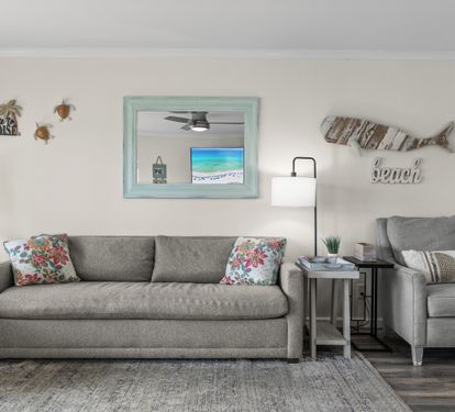 Sink into plush seating with tropical touches and beach-themed decor creating your perfect coastal retreat atmosphere.