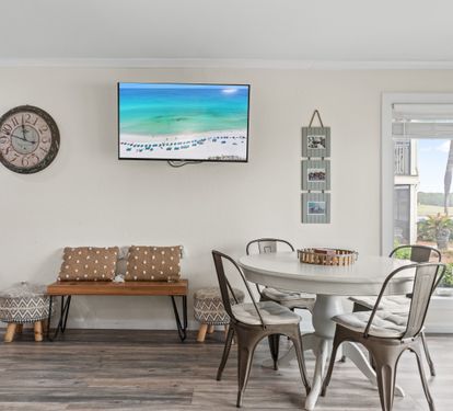 Gather around your stylish dining table while enjoying the large TV and beautiful natural light streaming through your windows.